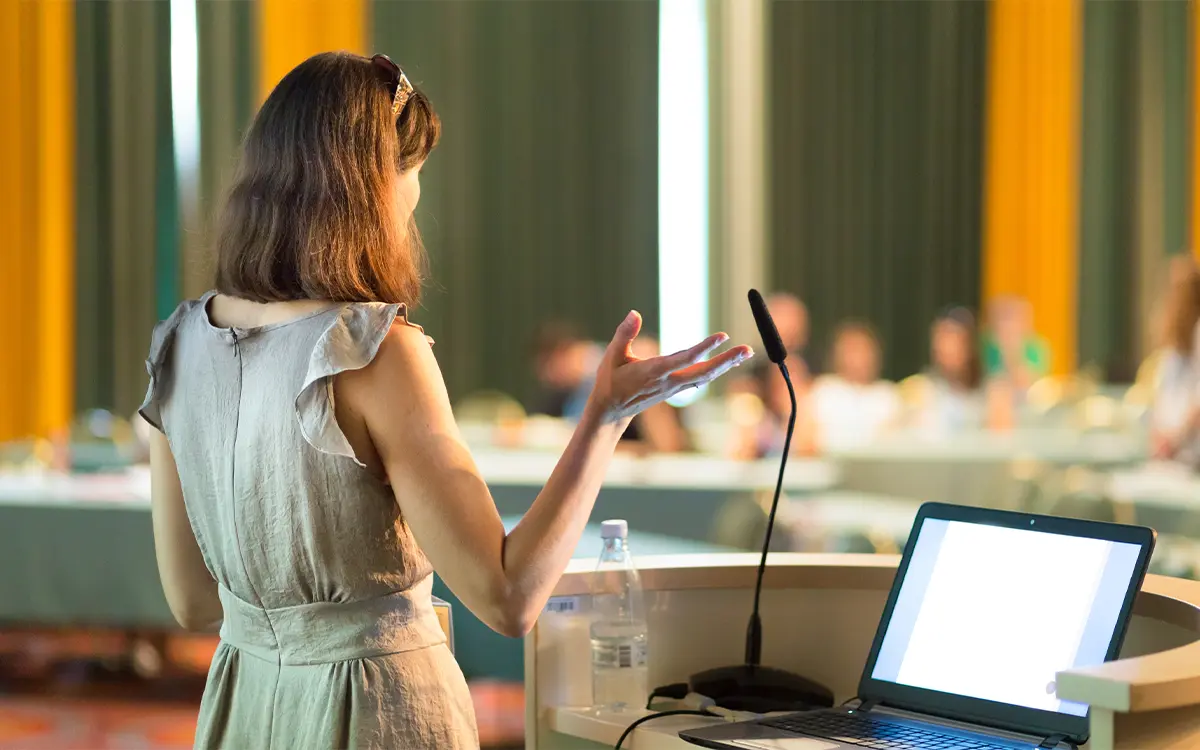 Woman giving a prepared speech at a conference